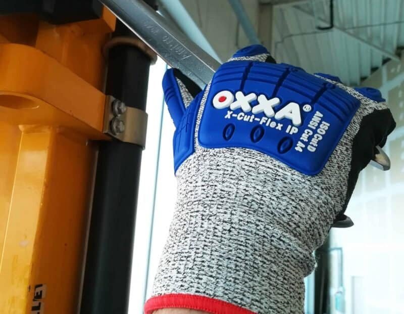 Robust work glove with protective wrist strap for outdoor work and chores.