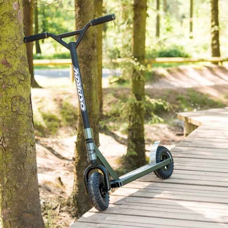 Robust kick scooter with wide wheels, suitable for outdoors and exploring trail courses.