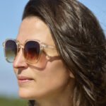 Cool Shoe Corp. Barby Orange Sunglasses with UV400 protection and transparent orange frame - worn by a lady